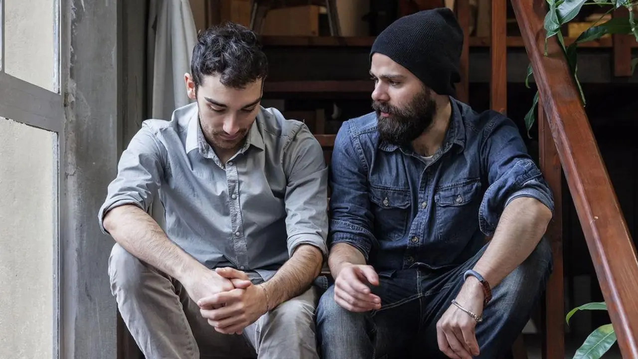 Person gently explaining the Bible to a new believer in a relaxed setting